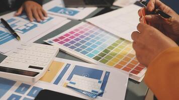 A person is working on a computer with a pen and a color palette video