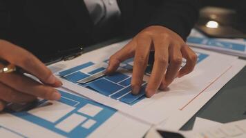 A person is working on blueprints with a pen video