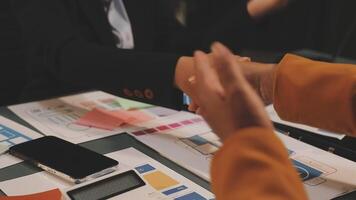 Business people shaking hands over a table with papers video