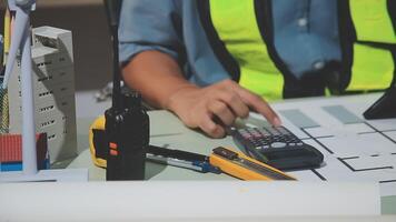 A person in a safety vest is using a calculator video