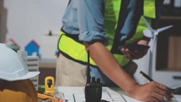 A man in a safety vest is working on a project video