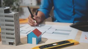 A man is working on a model of a house video