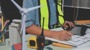 A man in a safety vest is working on a project video