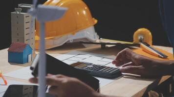 A man is using a calculator to calculate the cost of a house video