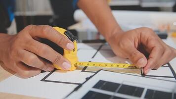 A person is measuring a piece of paper with a ruler video