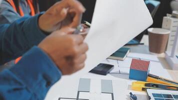 A man is holding a piece of paper while working on a project video