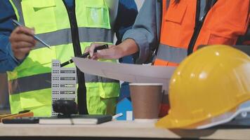 Two construction workers are working on a project video