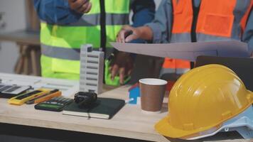 Two construction workers are working on a project video