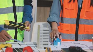 Two people in safety vests working on a project video