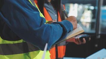 Two construction workers are working on a project video