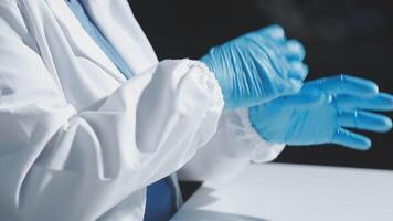 A person in a lab coat and blue gloves video