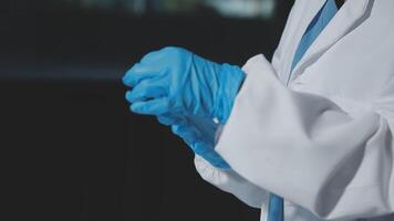 A person in a lab coat and blue gloves video