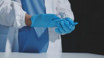 A person in a lab coat and blue gloves video