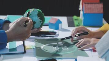 People working on a project with a globe on the table video