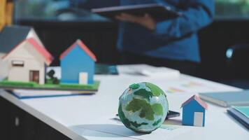 Earth model on table with house and people in background video