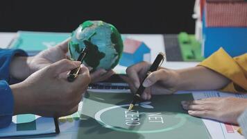 People working on a project with a green globe video