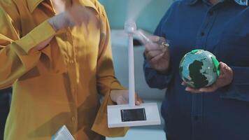 Two people holding a globe and a small object video