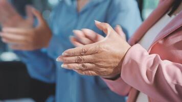 Close up of hands clapping in a meeting video