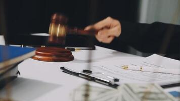 A judge's gavel on a desk with money and papers video
