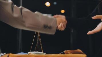 Two people shaking hands over a table with money on it video