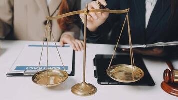 Two business people are holding scales on a desk video
