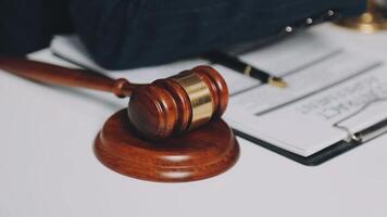 A judge's gavel on a desk with a legal document video