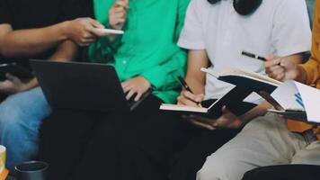 A group of people sitting on a couch with laptops video