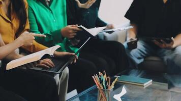 Group of people sitting around a table with laptops video