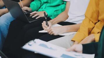 People sitting in a row with laptops and papers video