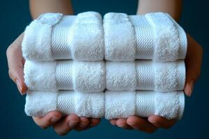Stacked White Towels in Hands for Spa, Hospitality, Relaxation Themes photo