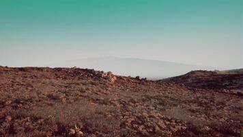 Expansive landscape with rocky terrain and distant mountains at sunrise video