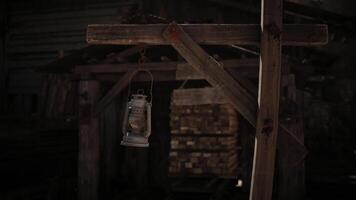 Rustic lantern hanging near a wooden structure in a dimly lit setting video