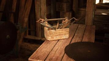 Old wooden toolbox with various hand tools on a rustic workbench in a workshop video