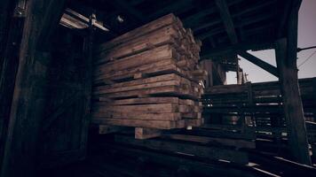 Stacks of wooden planks stored in a rustic warehouse during daylight video