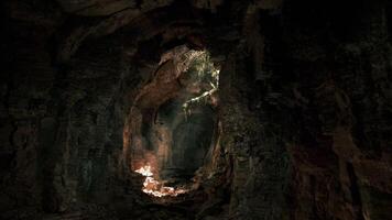 Mysterious underground cave illuminated by natural light filtering through video