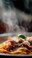 Spaghetti with meat sauce and basil leaves on a plate photo