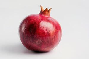 A pomegranate is shown on a white background photo