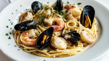 A plate of pasta with seafood and mussels photo
