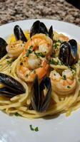 Pasta with shrimps, mussels and prawns photo