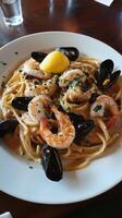 Seafood pasta with shrimps, mussels and lemon photo
