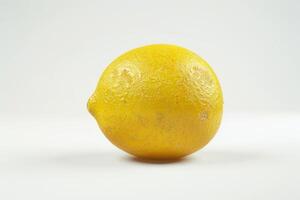 A lemon is shown on a white surface photo