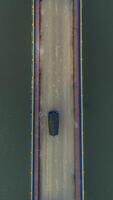 Aerial view of cars driving on a bridge with a river in the background photo