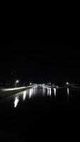 Night view of river at night with lights reflected on water surface. photo