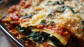 Close up of lasagna with spinach and parmesan cheese. photo