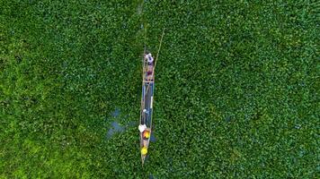 An aerial view of a boat in the middle of a green field photo