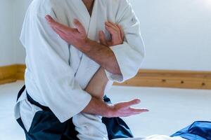 Man practicing aikido in a dojo background. photo