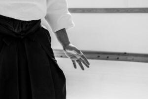 Man practicing aikido in a dojo background. photo