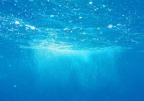 underwater view of the ocean surface with bubbles and bubbles photo