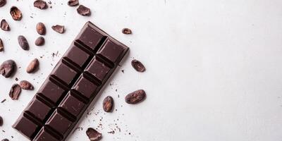 Modern branding mockup with unwrapped chocolate bar and cocoa beans on white background photo