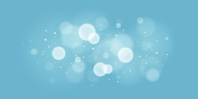 Soft focus light bokeh lights on blue background. Glittering sparkles and shining circles for festive themes. Winter bokeh lights